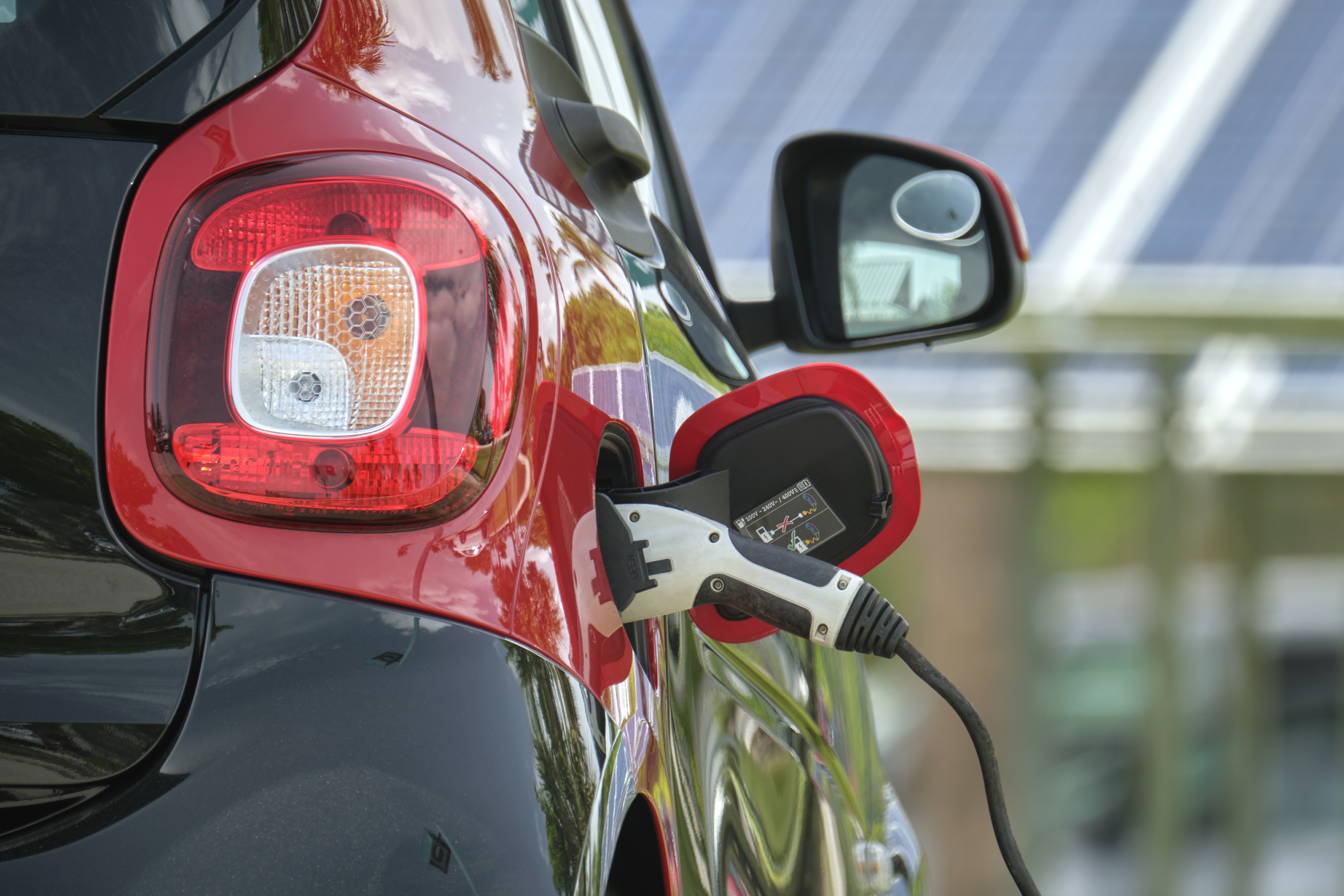 Electric plug-in car charging with electricity from solar renewable power source parked